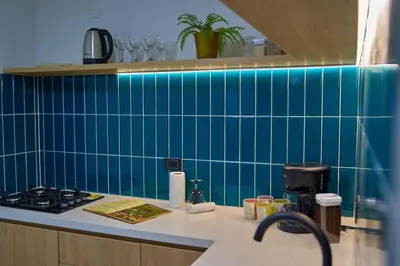 a kitchen with blue tiled walls and a counter at Casa en Laureles Estadio amplia y cómoda in Medellín