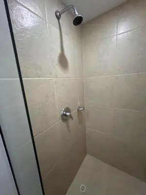 a shower with a glass door in a bathroom at Cómoda Habitación condominio, wifi, tv, piscina in Medellín