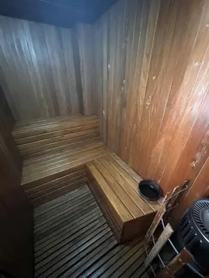 a small wooden sauna with a black at Cómoda Habitación condominio, wifi, tv, piscina in Medellín