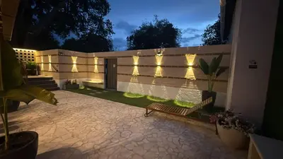 a patio with a bench and lights on a fence at Villa Patio Colonial Santa Fe de Antioquia in Santa Fe de Antioquia