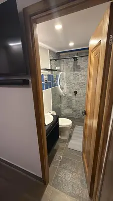 a bathroom with a toilet and a sink at Villa Patio Colonial Santa Fe de Antioquia in Santa Fe de Antioquia