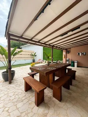 a large wooden table and benches in a patio at Villa Patio Colonial Santa Fe de Antioquia in Santa Fe de Antioquia