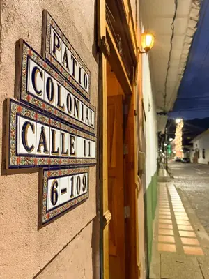 two signs on the side of a building at Villa Patio Colonial Santa Fe de Antioquia in Santa Fe de Antioquia