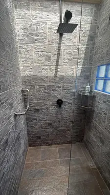 a shower with a glass door in a bathroom at Villa Patio Colonial Santa Fe de Antioquia in Santa Fe de Antioquia