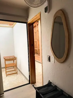 a room with a door and a mirror and a chair at Villa Patio Colonial Santa Fe de Antioquia in Santa Fe de Antioquia