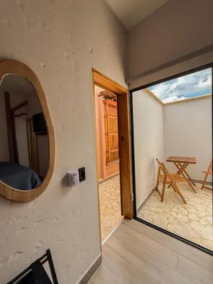 a room with a large window and a table at Villa Patio Colonial Santa Fe de Antioquia in Santa Fe de Antioquia