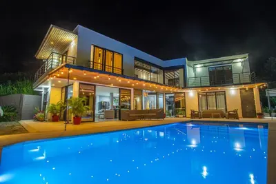 a house with a large swimming pool in front of it at Casa Finca Moderna en Sopetran, Antioquia in Sopetran