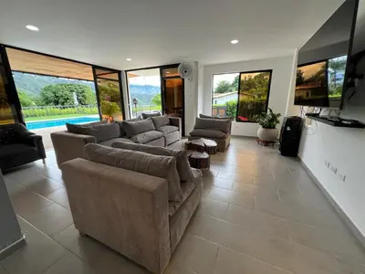 a large living room with couches and a tv at Casa Finca Moderna en Sopetran, Antioquia in Sopetran