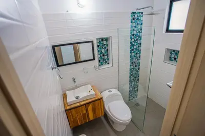 a bathroom with a toilet and a sink and a shower at Casa Finca Moderna en Sopetran, Antioquia in Sopetran