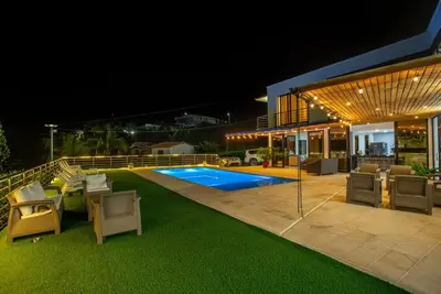 a house with a swimming pool at night at Casa Finca Moderna en Sopetran, Antioquia in Sopetran