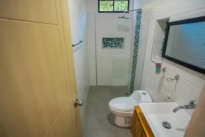 a bathroom with a toilet and a sink at Casa Finca Moderna en Sopetran, Antioquia in Sopetran