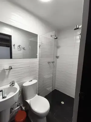 a bathroom with a toilet and a sink and a shower at Hotel LAS MARIANA'S in Medellín