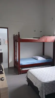 a bedroom with two bunk beds in a room at Finca La Catana, Naturaleza y Tranquilidad in Cocorná