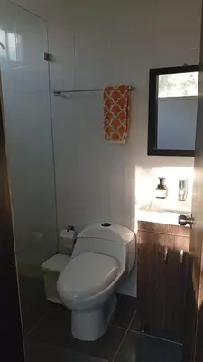 a bathroom with a white toilet and a sink at Finca La Catana, Naturaleza y Tranquilidad in Cocorná