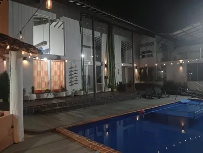 a house with a swimming pool at night at Finca La Catana, Naturaleza y Tranquilidad in Cocorná