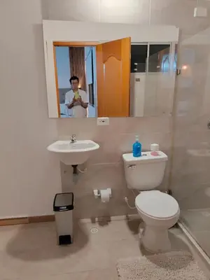 a man taking a picture of a bathroom with a toilet and sink at Diseño natural y espacioso, vista panorámica de Medellín 501 in Medellín