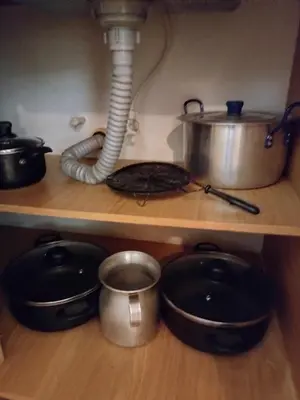 a kitchen shelf with pots and pans and a pot and a sink at Diseño natural y espacioso, vista panorámica de Medellín 501 in Medellín