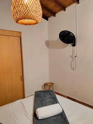 a room with a bed with a chair and a lamp at Diseño natural y espacioso, vista panorámica de Medellín 501 in Medellín