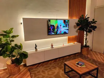 a living room with a tv on the wall at Diseño natural y espacioso, vista panorámica de Medellín 501 in Medellín