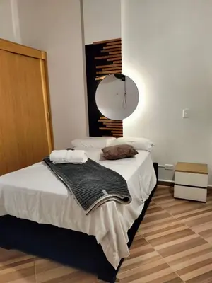 a bedroom with a bed with a lamp on it at Diseño natural y espacioso, vista panorámica de Medellín 501 in Medellín