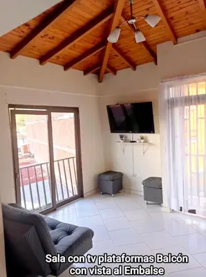 a living room with a couch and a flat screen tv at Guatape linda vista in Guatapé