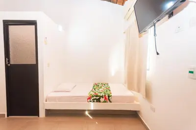 a small room with a small bed in the corner at Hotel Casa Encanto in Doradal
