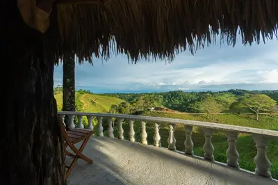 a balcony of a house with a view at Hotel Casa Encanto in Doradal