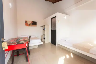a bedroom with a red desk and a bed at Hotel Casa Encanto in Doradal