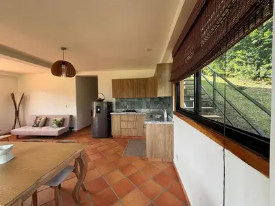 a kitchen with a large window in a room at Apto nuevo y moderno con piscina y bbq, zona rural in Anserma