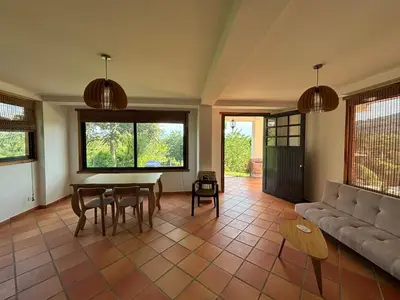 a living room with a couch and a table and chairs at Apto nuevo y moderno con piscina y bbq, zona rural in Anserma