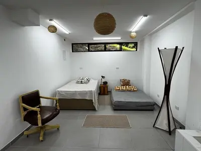 a room with a bed and a chair in it at Apto nuevo y moderno con piscina y bbq, zona rural in Anserma