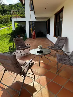 a patio with chairs and a table on a patio at Apto nuevo y moderno con piscina y bbq, zona rural in Anserma