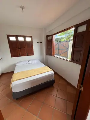 a small bedroom with a bed and a window at Hotel San Joaquin Jerico in Jericó