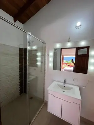 a bathroom with a sink and a glass shower at Hotel San Joaquin Jerico in Jericó