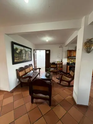 a living room with several chairs and a table at Hotel San Joaquin Jerico in Jericó