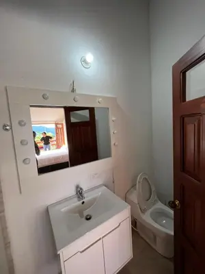 a bathroom with a sink and a toilet and a mirror at Hotel San Joaquin Jerico in Jericó