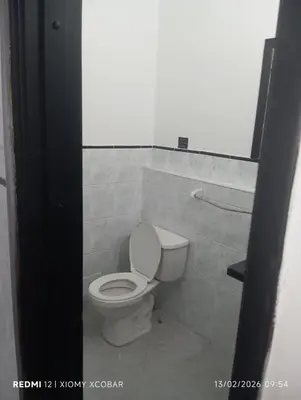 a bathroom with a white toilet in a room at Hotel eden centro in Medellín