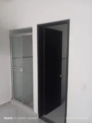 a black door in a room with a mirror at Hotel eden centro in Medellín