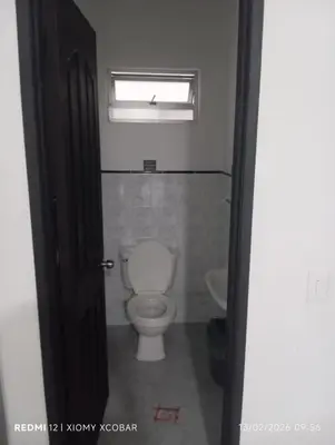 a bathroom with a toilet and a window at Hotel eden centro in Medellín