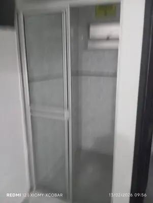 a glass refrigerator with its door open in a kitchen at Hotel eden centro in Medellín