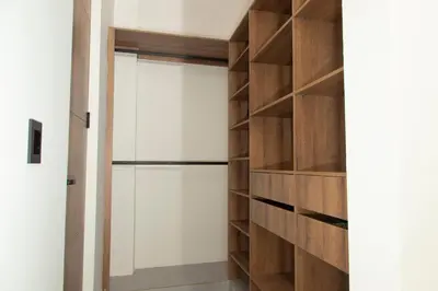 a room with a closet with wooden shelves at Villa with Pool, Jacuzzi, and Nature in Medellín