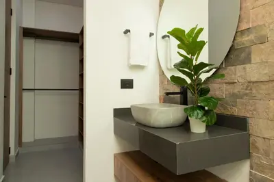 a bathroom with a sink and a mirror at Villa with Pool, Jacuzzi, and Nature in Medellín