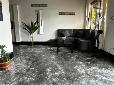a living room with a couch and a table at Casa Hotel Milagro de Abril in Mutatá