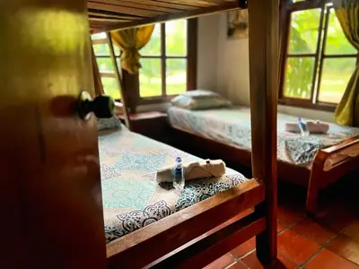 a room with two beds and a table with a napkin at La Cornalina in Santa Fe de Antioquia