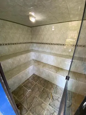 a shower with a glass door in a bathroom at La Cornalina in Santa Fe de Antioquia