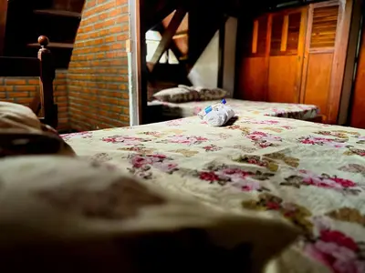 a bed with a blanket with a stuffed animal on it at La Cornalina in Santa Fe de Antioquia