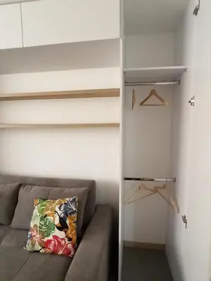 a living room with a couch and a closet at Vibra en el corazón de Medellin! in Medellín