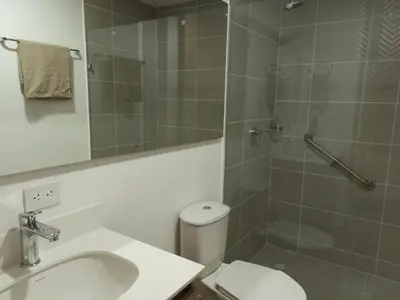 a bathroom with a toilet and a sink and a shower at Vibra en el corazón de Medellin! in Medellín