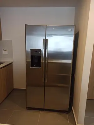 a stainless steel refrigerator in the corner of a kitchen at Vibra en el corazón de Medellin! in Medellín