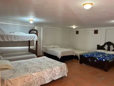 a room with two bunk beds and two beds at Finca El Saladero in Ebéjico